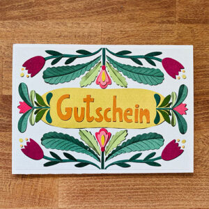 Gutschein in der digitalen Paper Cut-Methode erstellt. Das Wort "Gutschein" wird von Blumen und Blättern umrundet, die aussehen, als wären sie mit Papier gebastelt.